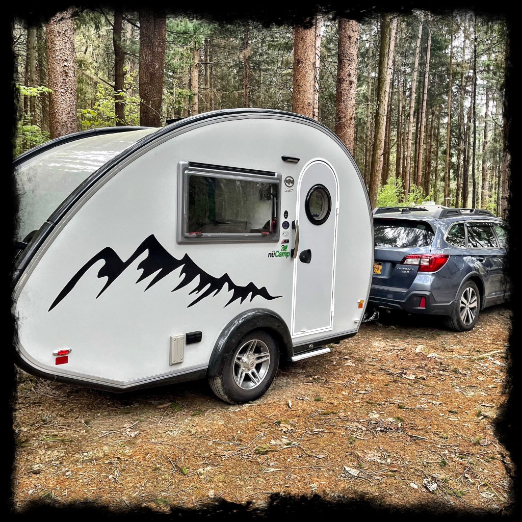 The camper packed up and hitched to a Subaru ready to drive