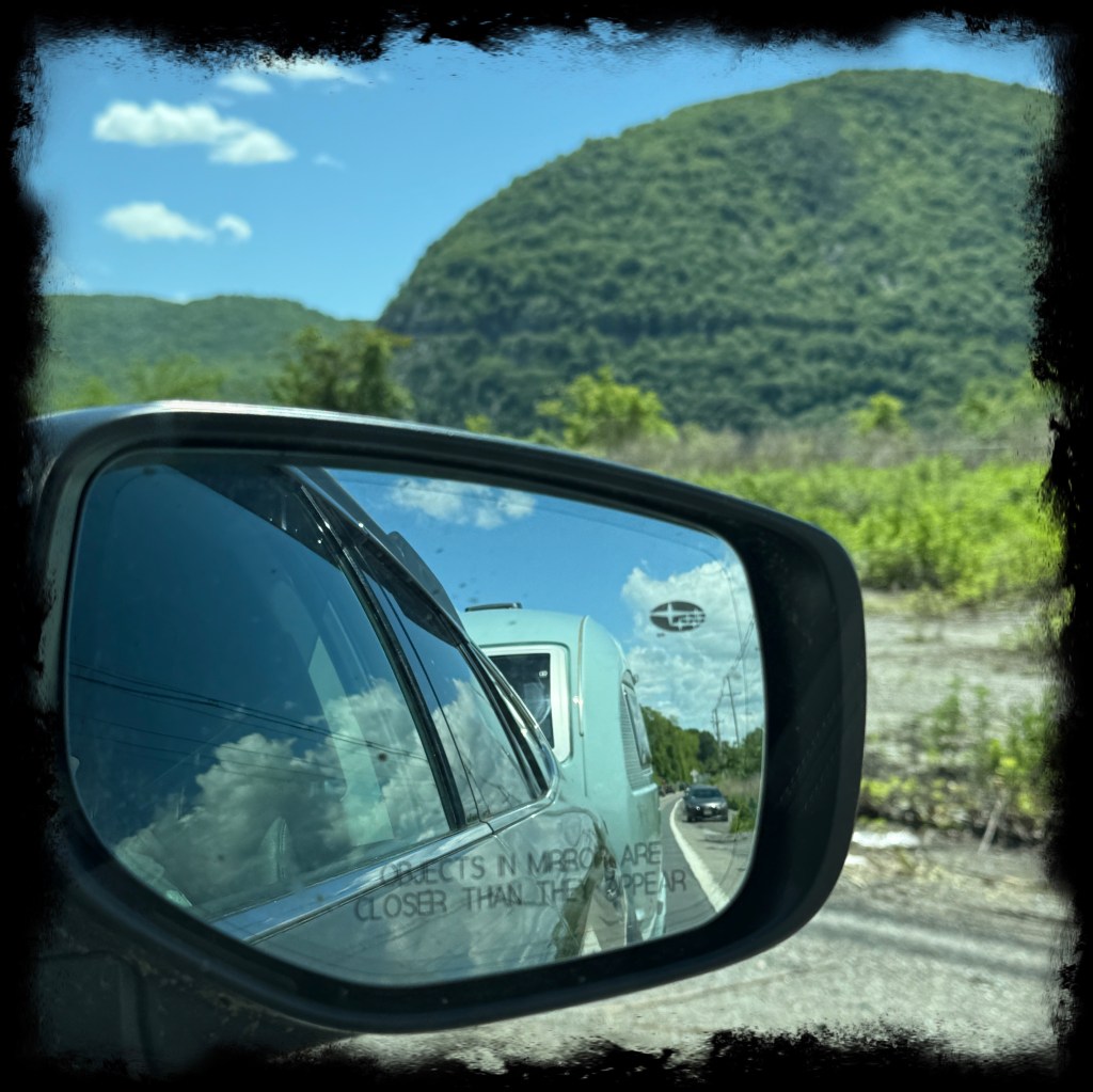 View of the Barefoot from the rearview mirror of the car, with Storm King Mountain in the background. 